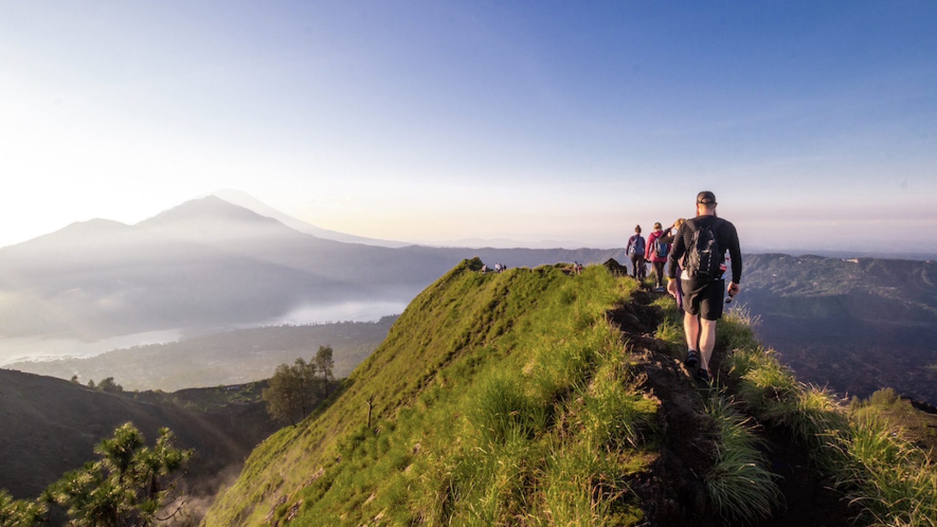 Hiking around the crater of Mount Batur with Mount Agung in the background